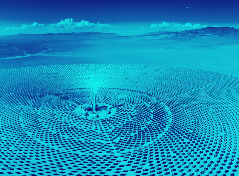 Photo of a solar farm in a desert, shown as a duotone in indigo and teal